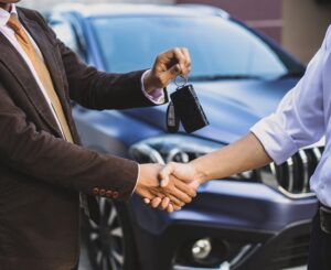 car-salesman-make-a-deal-and-hand-over-the-key-qgpkhp0lycsshbufp5duhgl3rswkjr762r2v1kf3f8